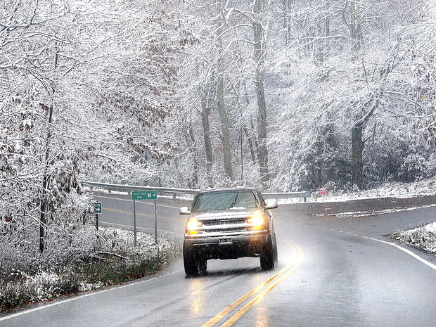 Snow sticking to tree limbs on Grandview Road in Beckley, V.Va. Monday Oct. 29, 2012 as Hurricane Sandy wheeled toward land. 