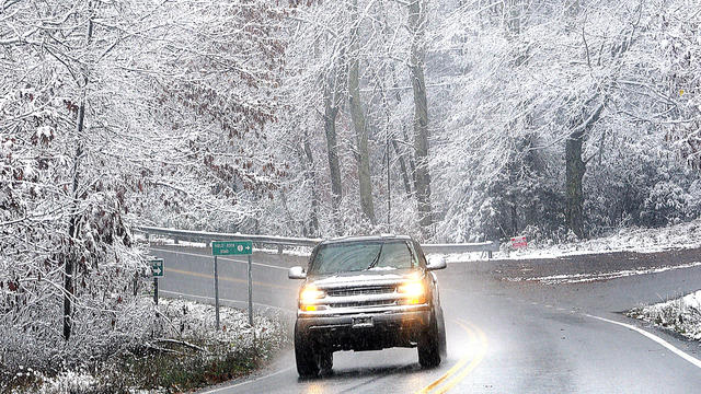 Snow sticking to tree limbs on Grandview Road in Beckley, V.Va. Monday Oct. 29, 2012 as Hurricane Sandy wheeled toward land. 