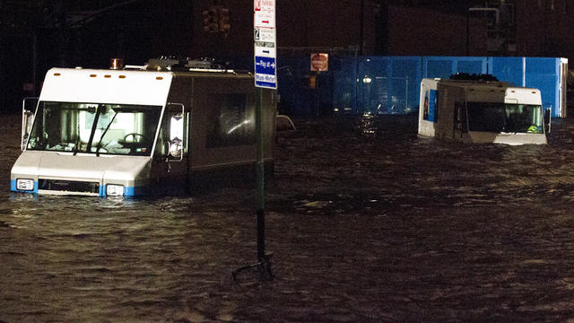 Consolidated Edision trucks are submerged on 14th Street near the ConEd power plant Oct. 29, 2012, in New York. 