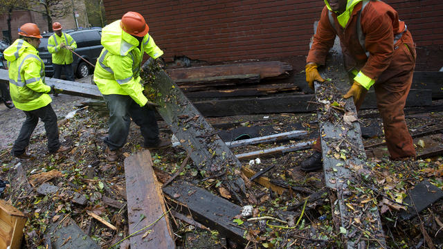 Workers clear debris outside the Consolidated Edison power substation on 14th Street Oct. 30, 2012. 