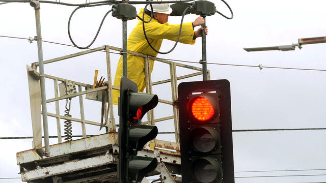 Nate Battle, an electrician for the City of Elmira, N.Y., fixes a traffic light that was downed from high winds caused by superstorm Sandy Oct. 30, 2012. 