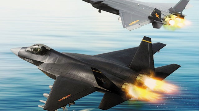 In this computer-generated picture, Chinese stealth fighters J-31, front, and J-20 fly over a naval fleet with Chinese aircraft carrier, The Liaoning. China tested the new J-31 fighter on Wednesday (31 October 2012) morning, becoming only the second count 