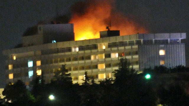 Smoke and flames light up the night from a blaze at the Intercontinental Hotel after Taliban fighters attacked it in Kabul, Afghanistan, June 29, 2011. 