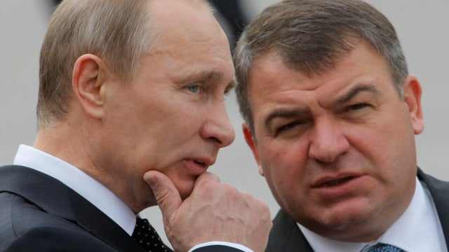 Russian Prime Minister Vladimir Putin and Russian Defense Minister Anatoly Serdyukov speak during a wreath laying ceremony at the Tomb of Unknown Soldier in Moscow, Sunday, May 8, 2011. 