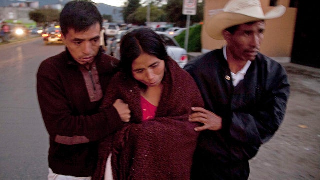 Relatives of Rosa Ramos transport her body 