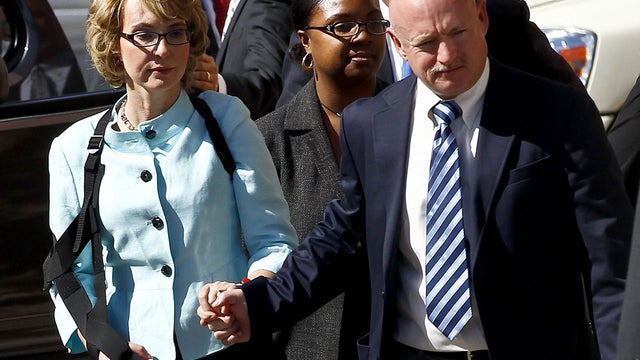 Former Democratic Rep. Gabrielle Giffords, left, and her husband Mark Kelly leave after the sentencing of Jared Loughner, in back of U.S. District Court Thursday, Nov. 8, 2012, in Tucson, Ariz.  