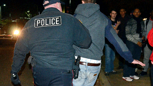 A University Police Department officer leads a protester away from a public disturbance on the campus of the University of Mississippi in Oxford, Miss., Wednesday morning, Nov. 7, 2012.  