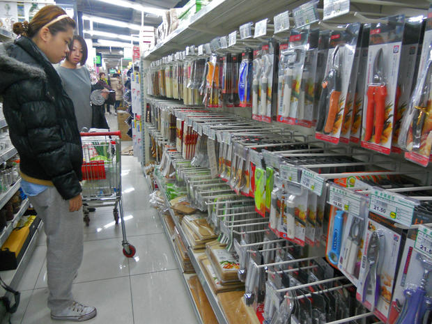 A shopper gazes at the shelves at a Beijing supermarket where all of the kitchen knives were been removed 