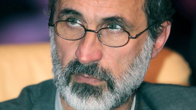 Muslim cleric Mouaz al-Khatib, poses for a photo after after he was elected president of the newly formed Syrian National Coalition for Opposition and Revolutionary Forces 