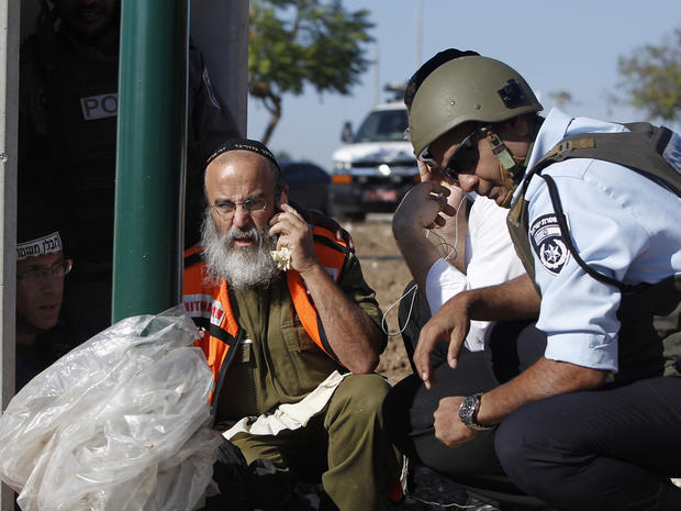 Israeli security personnel take cover in Kiryat Malachi 