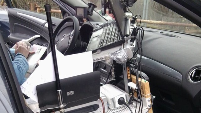 A vehicle with its interior wired up like a mobile office stopped on the autobahn. 