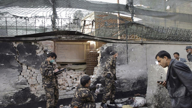 Afghan security forces inspect scene at a U.S. base in Kabul Nov. 21, 2012 after, officials say, two would-be suicide bombers were shot as they approached 