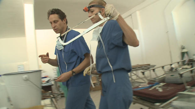 Doctors in Haiti holding hacksaws to perform amputations following the earthquake 