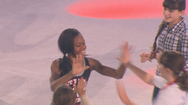 Gabby high-fives her fans while on tour 
