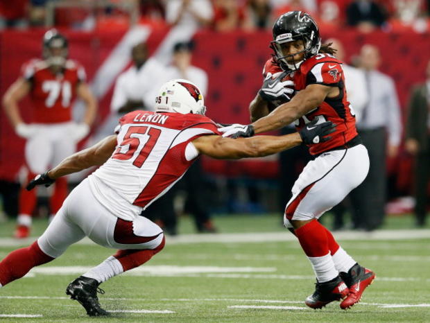 Jacquizz Rodgers #32 of the Atlanta Falcons tries to break a tackle by Paris Lenon #51 of the Arizona Cardinals 
