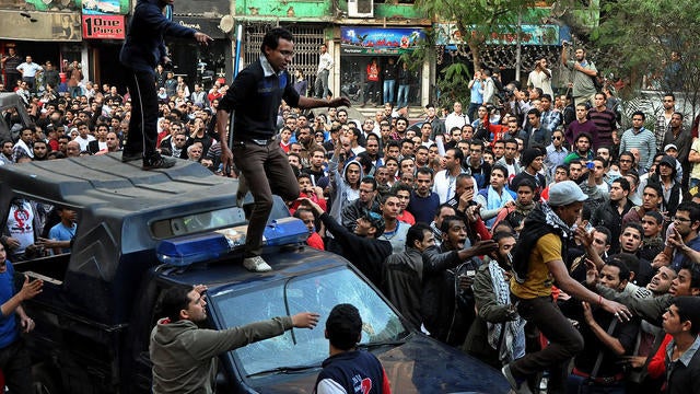 Egyptians stand on police vehicles during the funeral of Gaber Salah, who was who was killed in clashes with security forces in Cairo, Egypt, Nov. 26, 2012.  