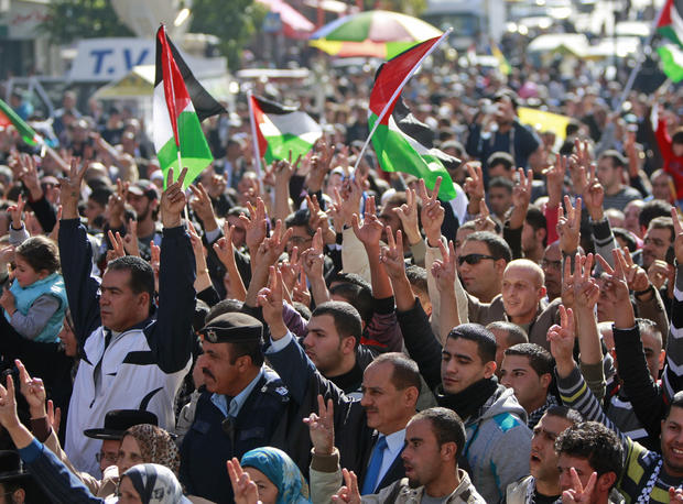 People wave Palestinian flags during a rally supporting the Palestinian UN bid for observer state status, in the West bank city of Ramallah, Thursday, Nov. 29, 2012. 