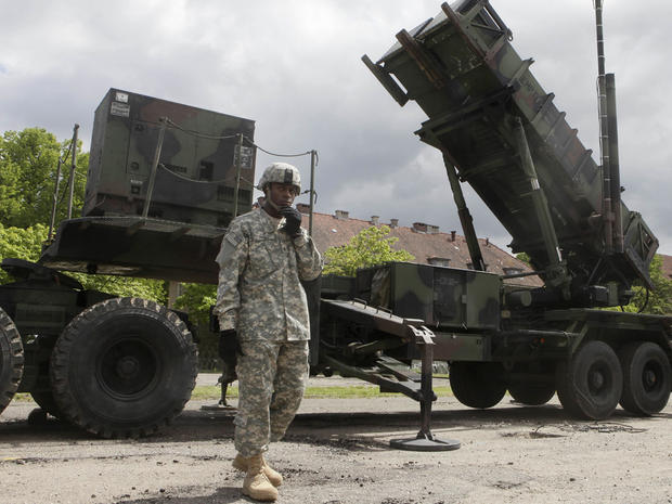 A U.S. soldier stands next to a Patriot surface-to-air missile battery 