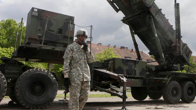 A U.S. soldier stands next to a Patriot surface-to-air missile battery 