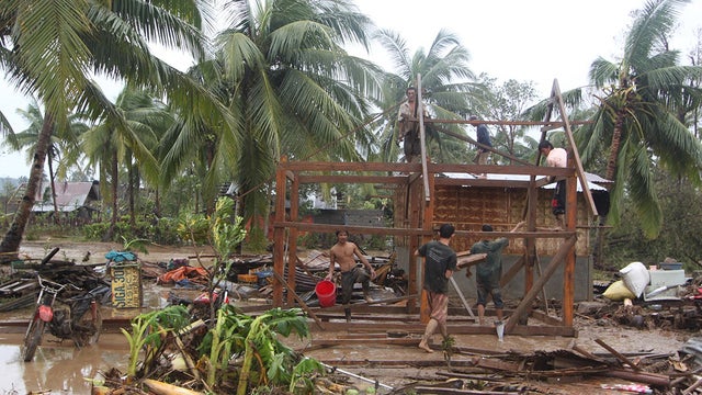 Residents repair their damaged homes after Typhoon Bopha made landfall in Compostela Valley in southeastern Philippines, Dec. 4, 2012.  