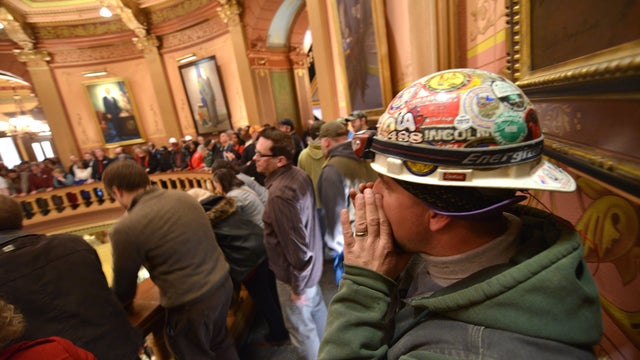 Brett Brown or Owosso, Mich., chants as Pro-union demonstrators crowd the Rotunda in Lansing, Mich., to chant Wednesday afternoon Dec. 5, 2012, in the Capitol after House and Senate Democrats said there was a possibility of "Right To Work" legislation com 
