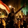 Egyptian protesters chant slogans against the Muslim Brotherhood and Egyptian President Mohammed Morsi outside the presidential palace after they broke a barbed wire barricade in Cairo Dec. 7, 2012. 