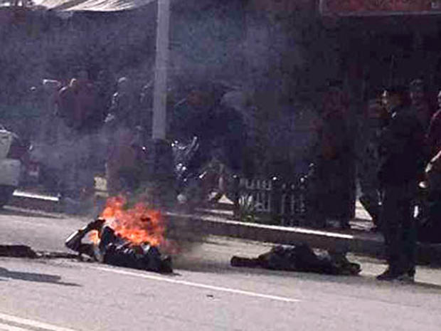 Dorje Rinchen lays on the ground after setting himself on fire 