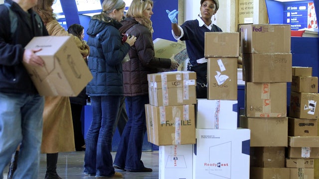 People wait on line to mail packages ahead of the Christmas holiday at the James A. Farley Post Office in Manhattan Dec. 20, 2010, in New York City. 