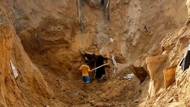 An Israeli soldier guides a tank to a new position at a staging area near the Israel-Gaza Strip border 
