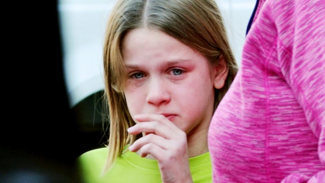 A young girl cires following a shooting at the Sandy Hook Elementary School in Newtown, Conn., about 60 miles (96 kilometers) northeast of New York City, Friday, Dec. 14, 2012. A gunman entered the school Friday morning and killed at least 26 people, incl 