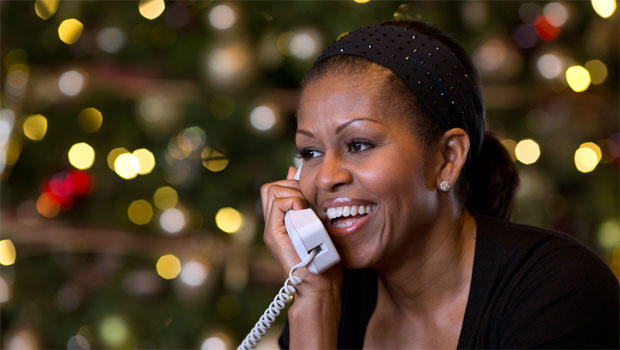 First Lady Michelle Obama reacts while talking on the phone to children across the country as part of the annual NORAD Tracks Santa program. Mrs. Obama answered the phone calls from Kailua, Hawaii, Christmas Eve, Dec. 24, 2012. 