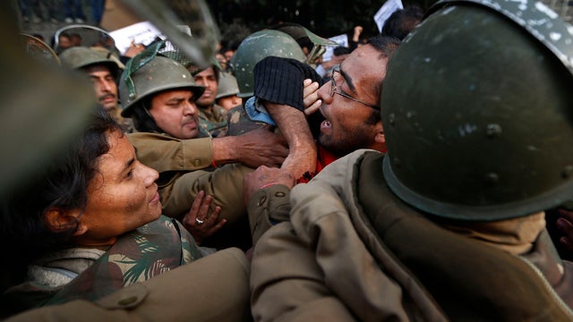 Policemen stop protesters from approaching barricade on way to India Gate while protesting over gang-rape of young woman in moving bus in New Delhi, India, Dec. 27, 2012. 