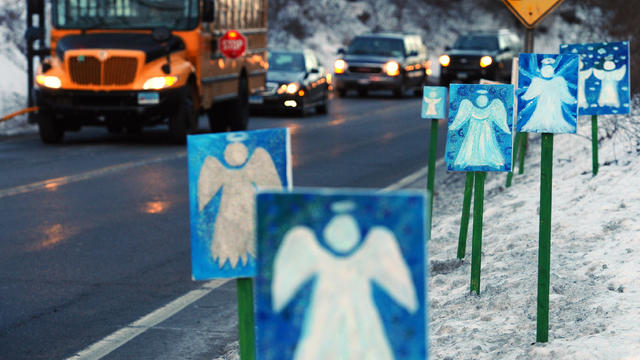 A bus traveling from Newtown, Conn., to Monroe stops in front of 26 angels along the roadside Jan. 3, 2013, the first day of classes for Sandy Hook Elementary students since the Dec. 14, 2012, shooting. 