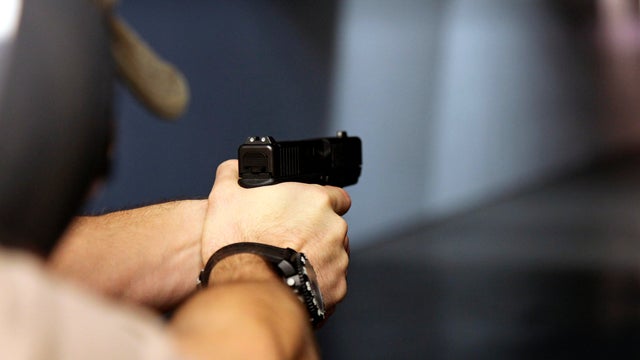 A man fires a handgun at Sandy Springs Gun Club and Range in Sandy Springs, Ga., Jan. 4, 2013. 