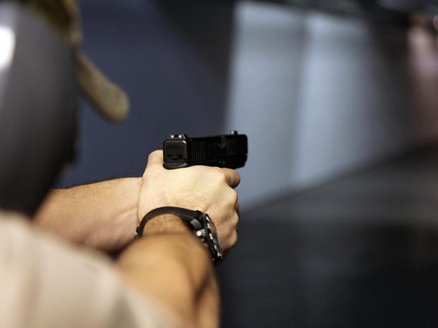 A man fires a handgun at Sandy Springs Gun Club and Range in Sandy Springs, Ga., Jan. 4, 2013. 