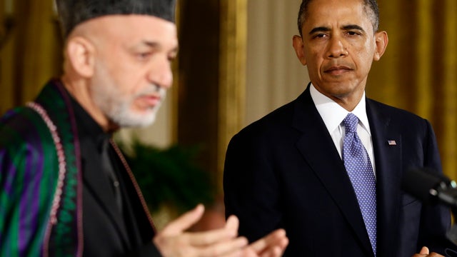 President Obama listens as Afghan President Hamid Karzai speaks during their joint news conference in the East Room of the White House in Washington Jan. 11, 2013. 