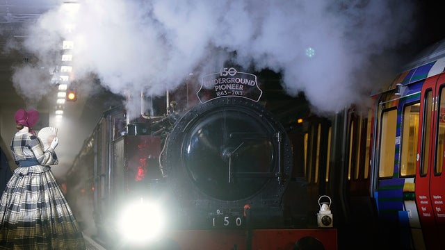 A restored 1898 steam engine known as Met Locomotive No. 1 arrives at London's Moorgate station 