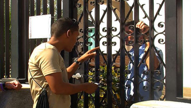 Berni Tornes speaks to a Canadian Embassy official through the gate. 