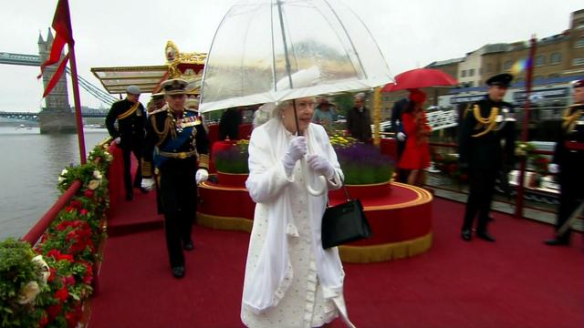 Queen Elizabeth shields herself from the rain during the Diamond Jubilee in June 2012. 