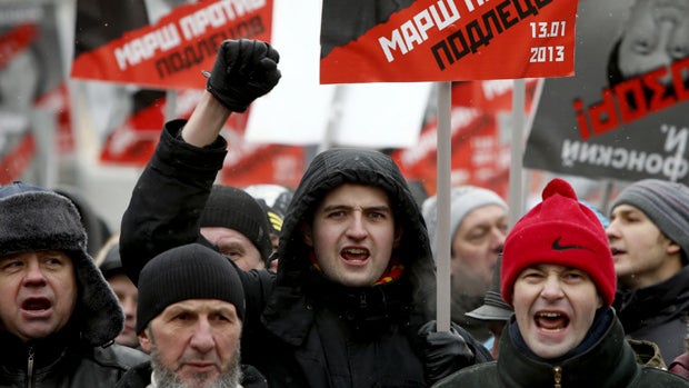 People shout during a protest rally in Moscow, Russia, Sunday, Jan. 13, 2013. Thousands of people are gathering in central Moscow for a protest against Russia's new law banning Americans from adopting Russian children. 