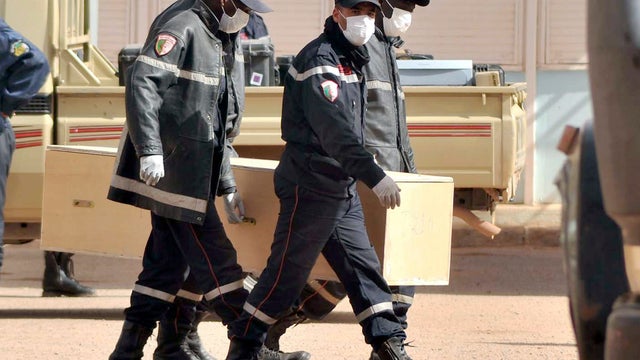 Algerian firemen carry a coffin containing the body of a person killed during the hostage situation in a gas plant at the morgue in Ain Amenas, Algeria, Jan. 21, 2013. 