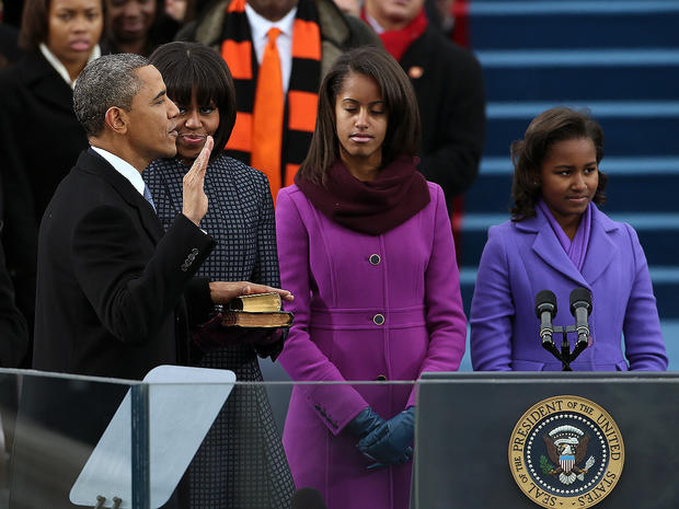 U.S. President Barack Obama is sworn in during the public ceremony as First lady Michelle Obama, and daughters, Sasha Obama and Malia Obama look on during the presidential inauguration on the West Front of the U.S. Capitol January 21, 2013 in Washington,  