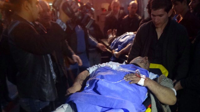 A man injured by a suicide bomber in Kirkuk, Iraq, Jan. 23, 2013, is transferred to a local hospital for treatment. 