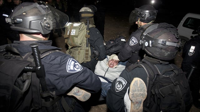 Israeli border police evict a Palestinian protester from the controversial West Bank area known as E1 