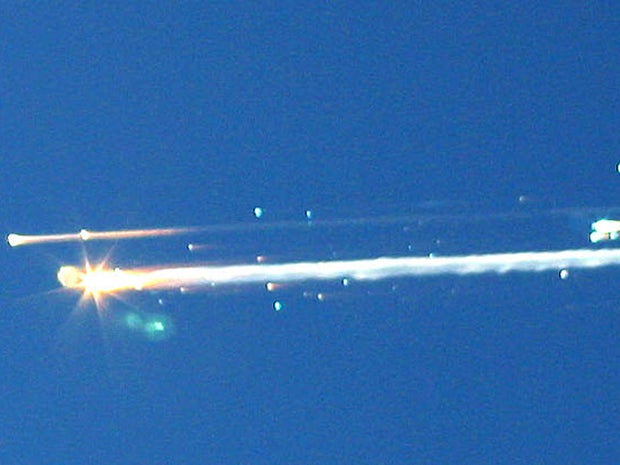 In this Feb. 1, 2003 file photo, debris from the space shuttle Columbia streaks across the sky over Tyler, Texas. The Columbia broke apart in flames 200,000 feet over Texas on Saturday, killing all seven astronauts just minutes before they were to glide t