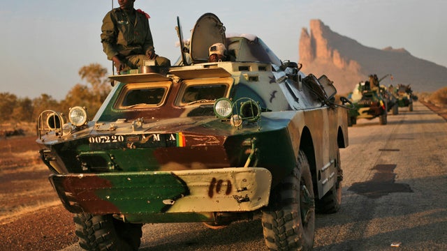 A convoy of Malian troops makes a stop to test some of their weapons near Hambori, northern Mali 