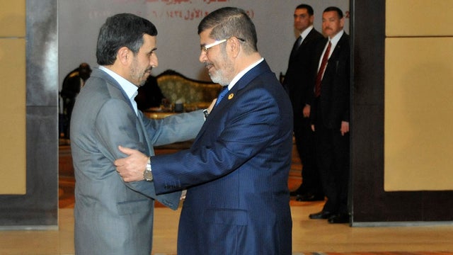 Egyptian President Mohammed Morsi, right, embraces Iranian President Mahmoud Ahmadinejad 