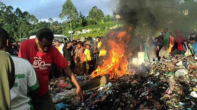 Bystanders watch as a woman accused of witchcraft is burned alive 