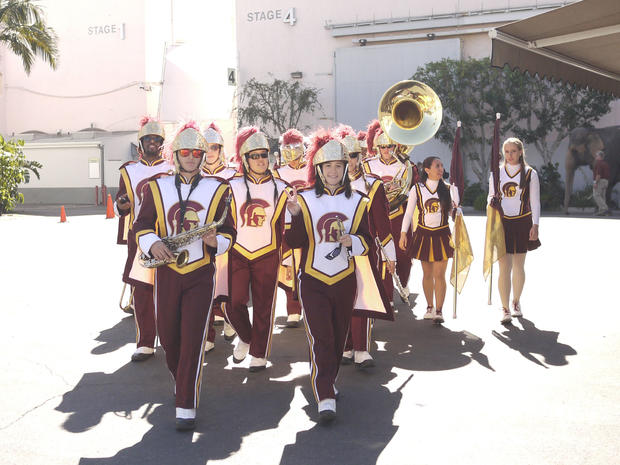 Members of the USC Trojan Marching Band parade through the set.  