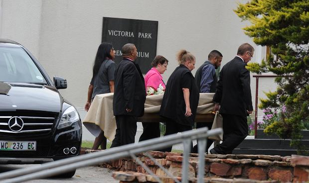 Pallbearers carry the coffin of late South African model Reeva Steenkamp into the crematorium 